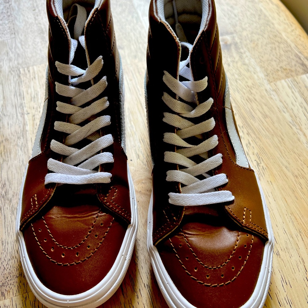 Brown and white Vans size 7.5 in US women’s. Never worn